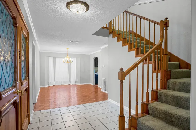 a view of a livingroom with furniture and stairs