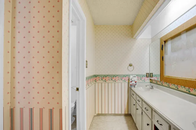 a bathroom with a double vanity sink a mirror and a