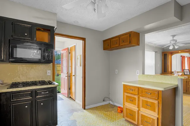 a kitchen with a sink stove and microwave