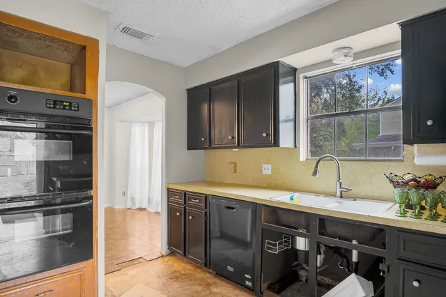 a view of a yard with a small yard and wooden fence