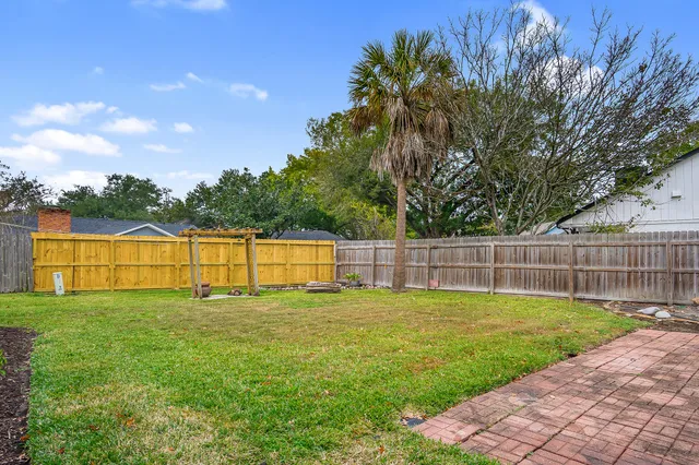 a view of a yard with a house in the background