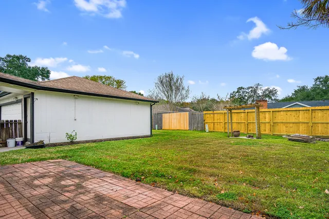 a view of a house with a yard and garage