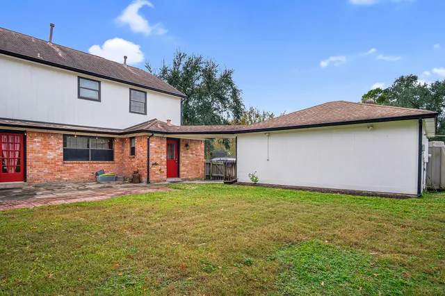 a backyard of a house with table and chairs