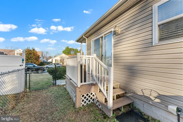 a view of a house with a yard and deck