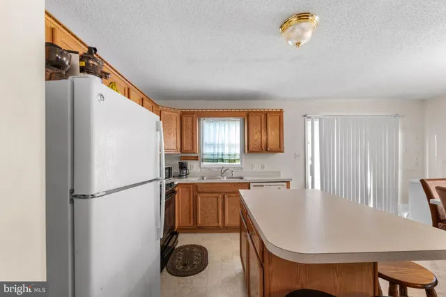 a kitchen with a table chairs and refrigerator