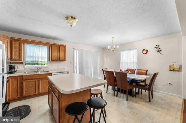 a view of a dining room with furniture and a window