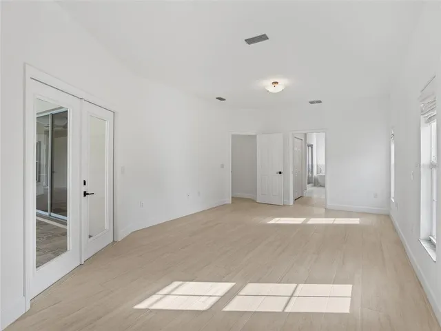 a front view of a house with a yard and potted plants