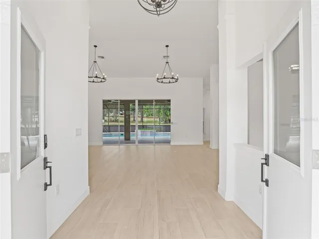 wooden floor in an empty room with a bathroom