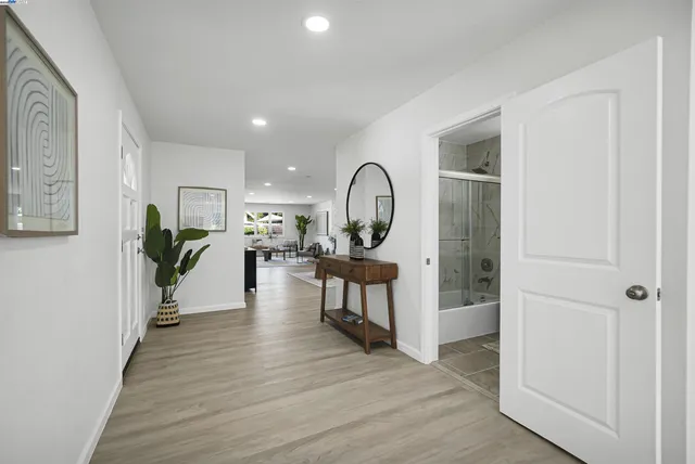 a living room with furniture and kitchen view