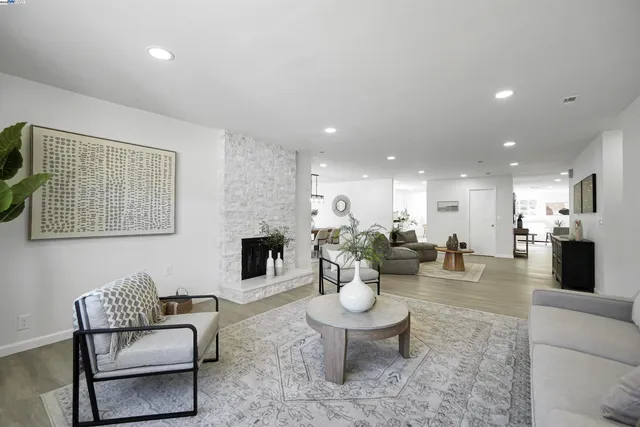 a kitchen with granite countertop white cabinets and stainless steel appliances