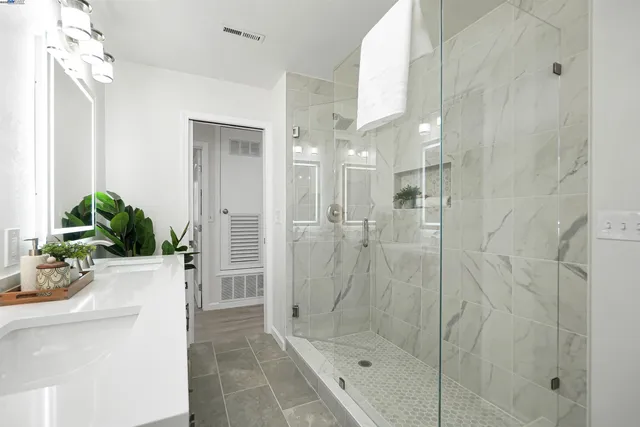 a view of a chair and table in backyard with wooden fence