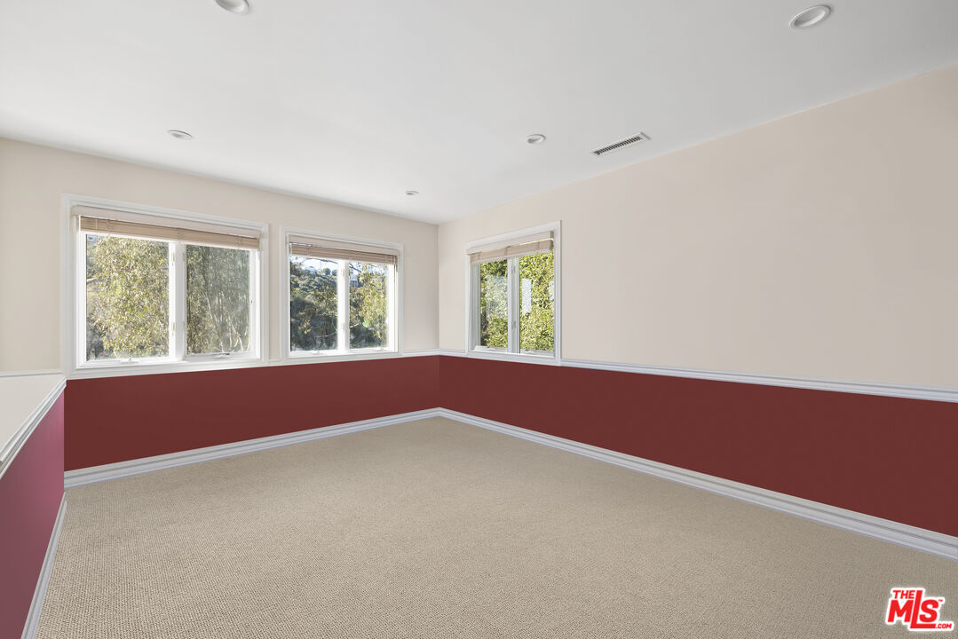 10557 Rocca Place Los Angeles, CA 90077 - Photo 11 of 19 an empty room with windows