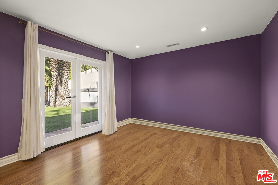 10557 Rocca Place Los Angeles, CA 90077 - Photo 14 of 19 a view of an empty room with wooden floor and a window