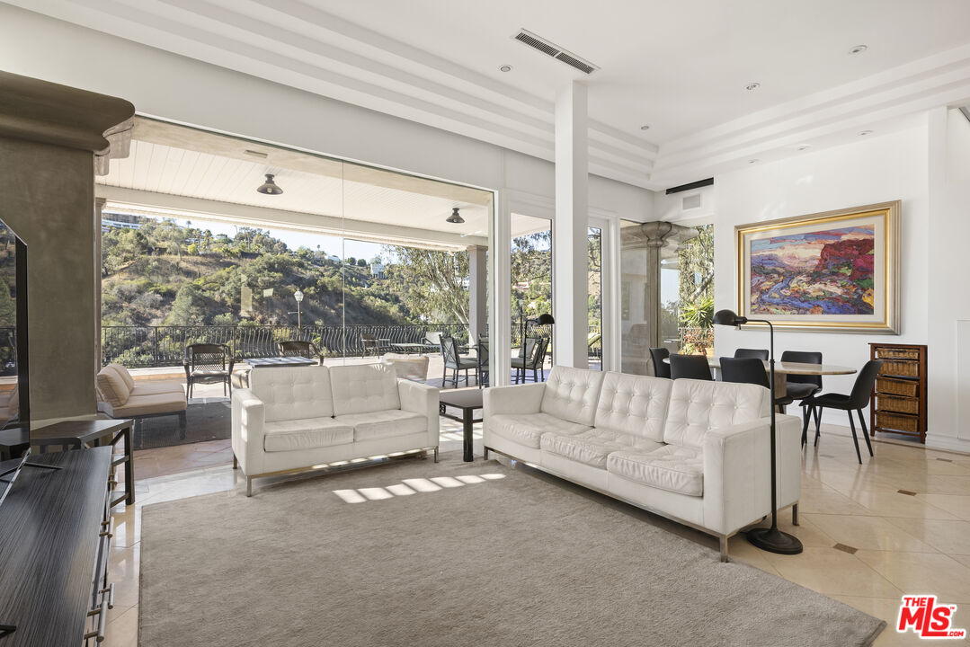 10557 Rocca Place Los Angeles, CA 90077 - Photo 3 of 19 a living room with furniture and a large window