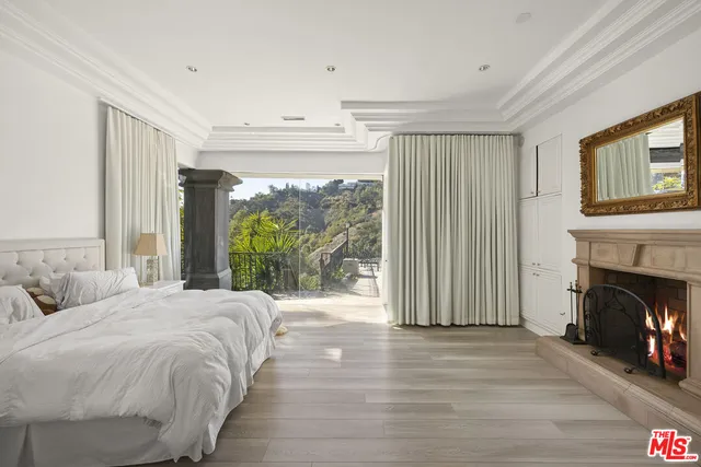 a spacious bedroom with a bed and a fireplace