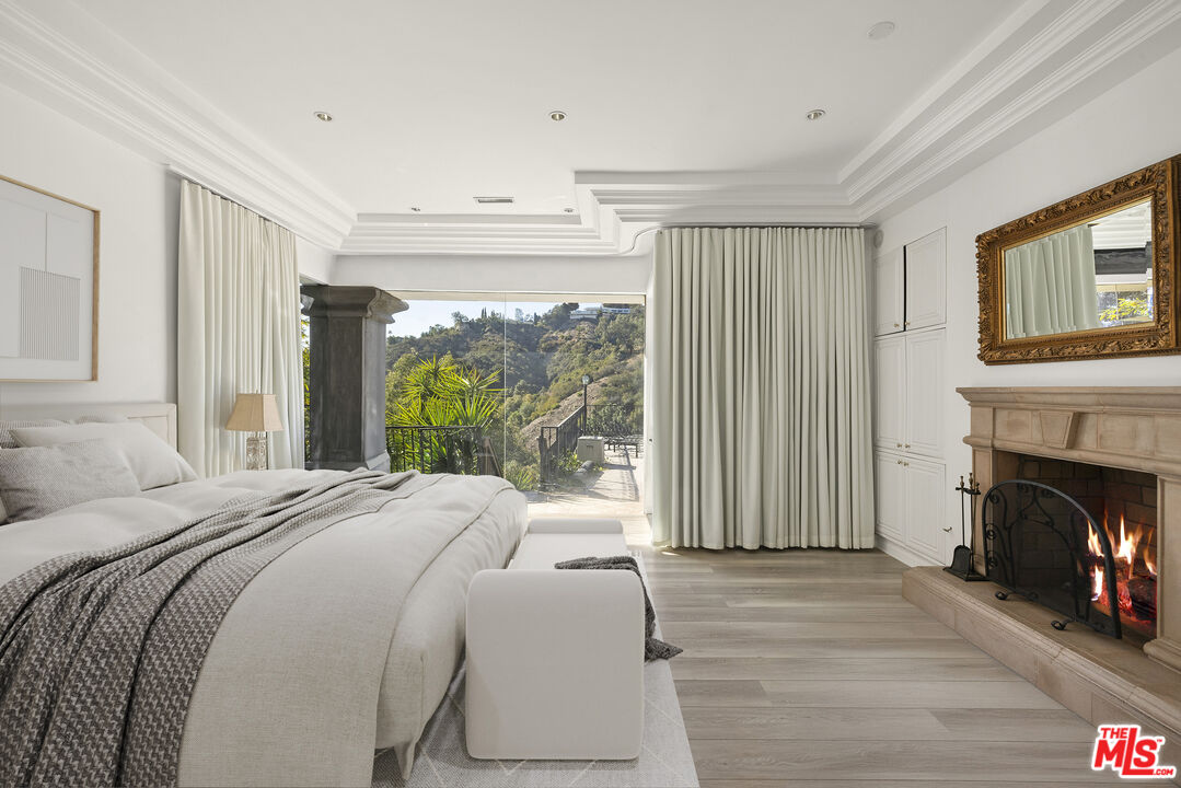 10557 Rocca Place Los Angeles, CA 90077 - Photo 9 of 19 a bed sitting in a spacious bedroom next to a window