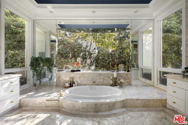 a living room with large window and furniture