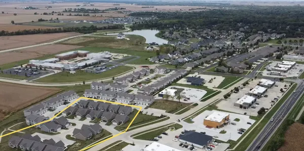 an aerial view of a residential houses with outdoor space