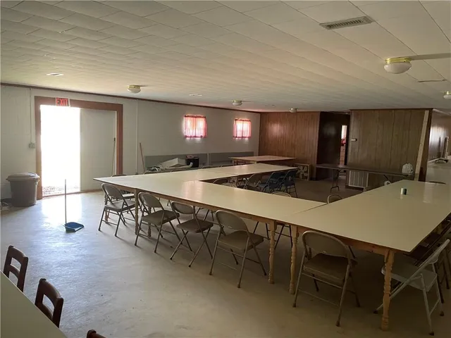a large kitchen with a table and chairs