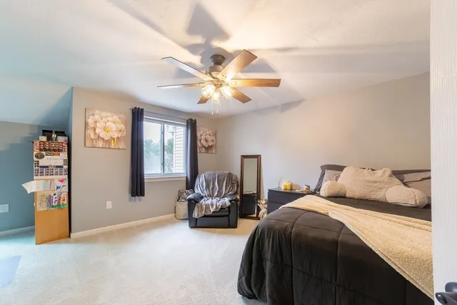 a bedroom with furniture and a large window