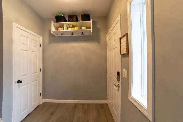 a kitchen with kitchen island granite countertop a refrigerator a sink a stove top oven and a refrigerator