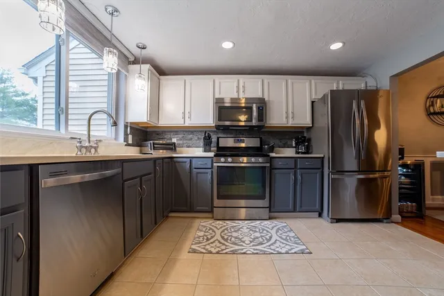 a kitchen with granite countertop a stove and a microwave