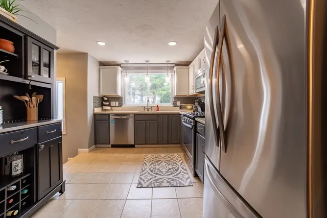 a kitchen with cabinets and refrigerator
