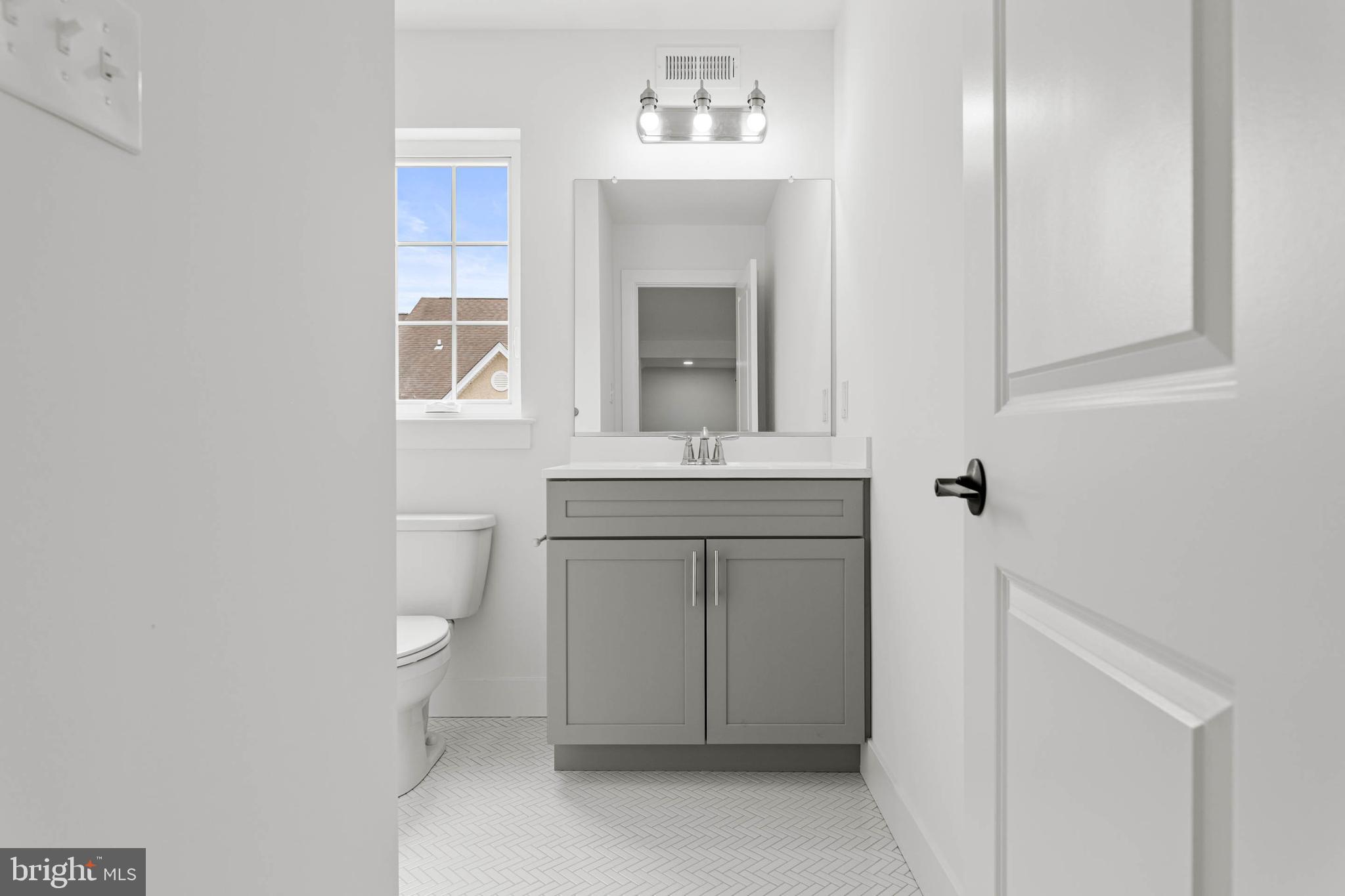 211 8th Street Bridgeport, PA 19405 - Photo 12 of 17 a bathroom with a sink toilet and mirror