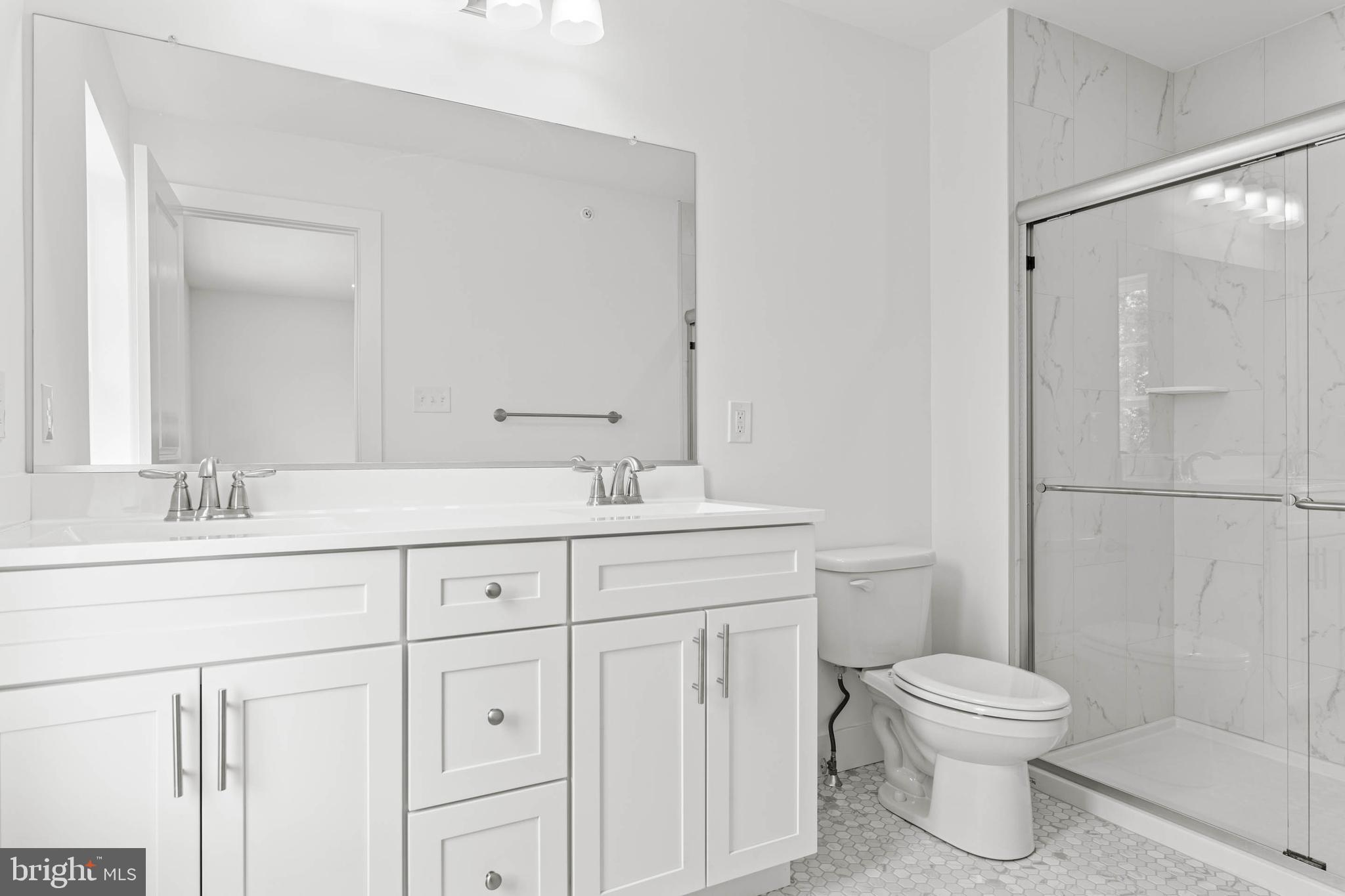 211 8th Street Bridgeport, PA 19405 - Photo 8 of 17 a bathroom with a toilet a sink a vanity and mirror