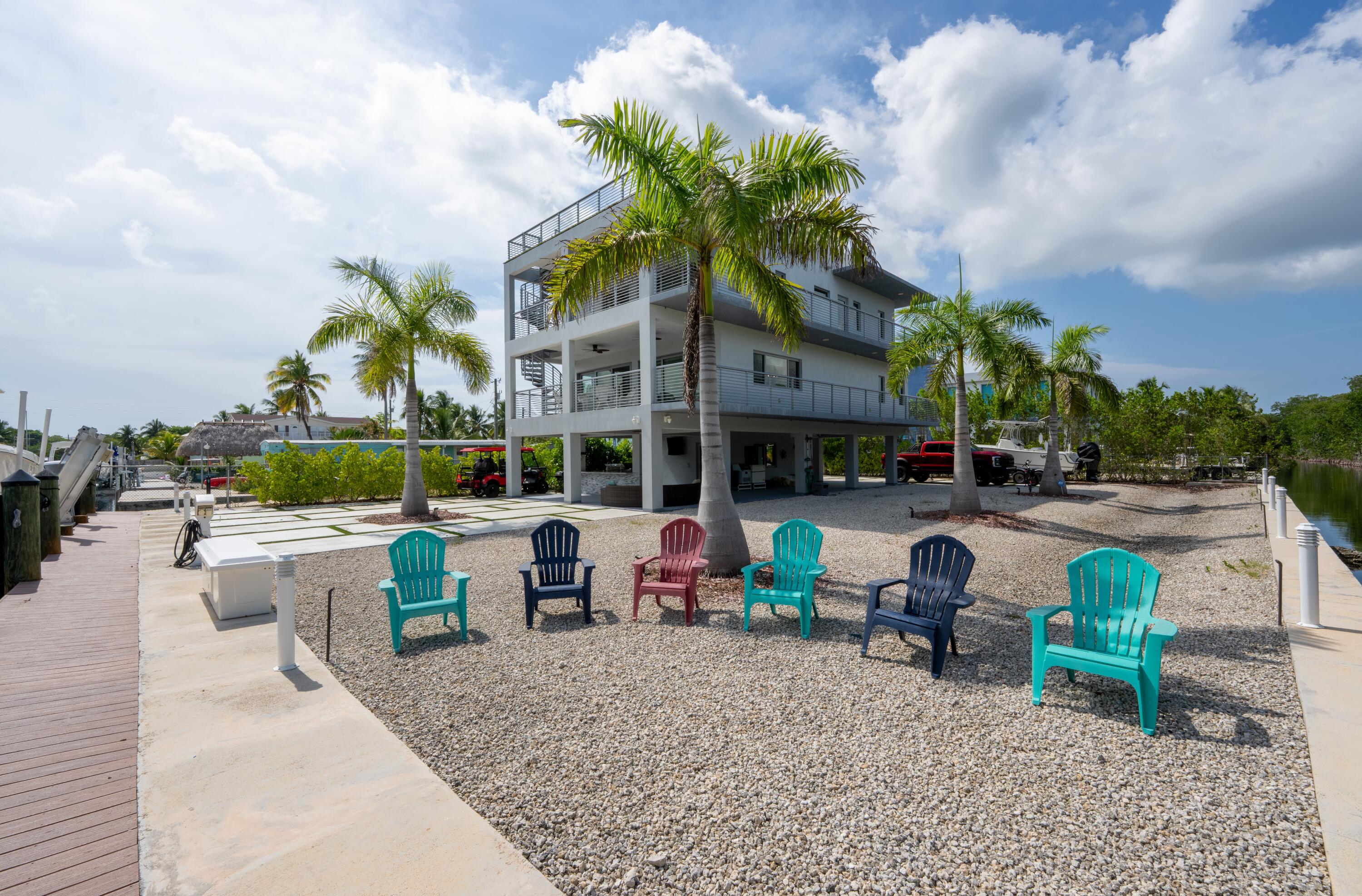 475 Bahia Honda Road Key Largo, FL 33037 - Photo 2 of 134 a front view of a house with garden and sitting area