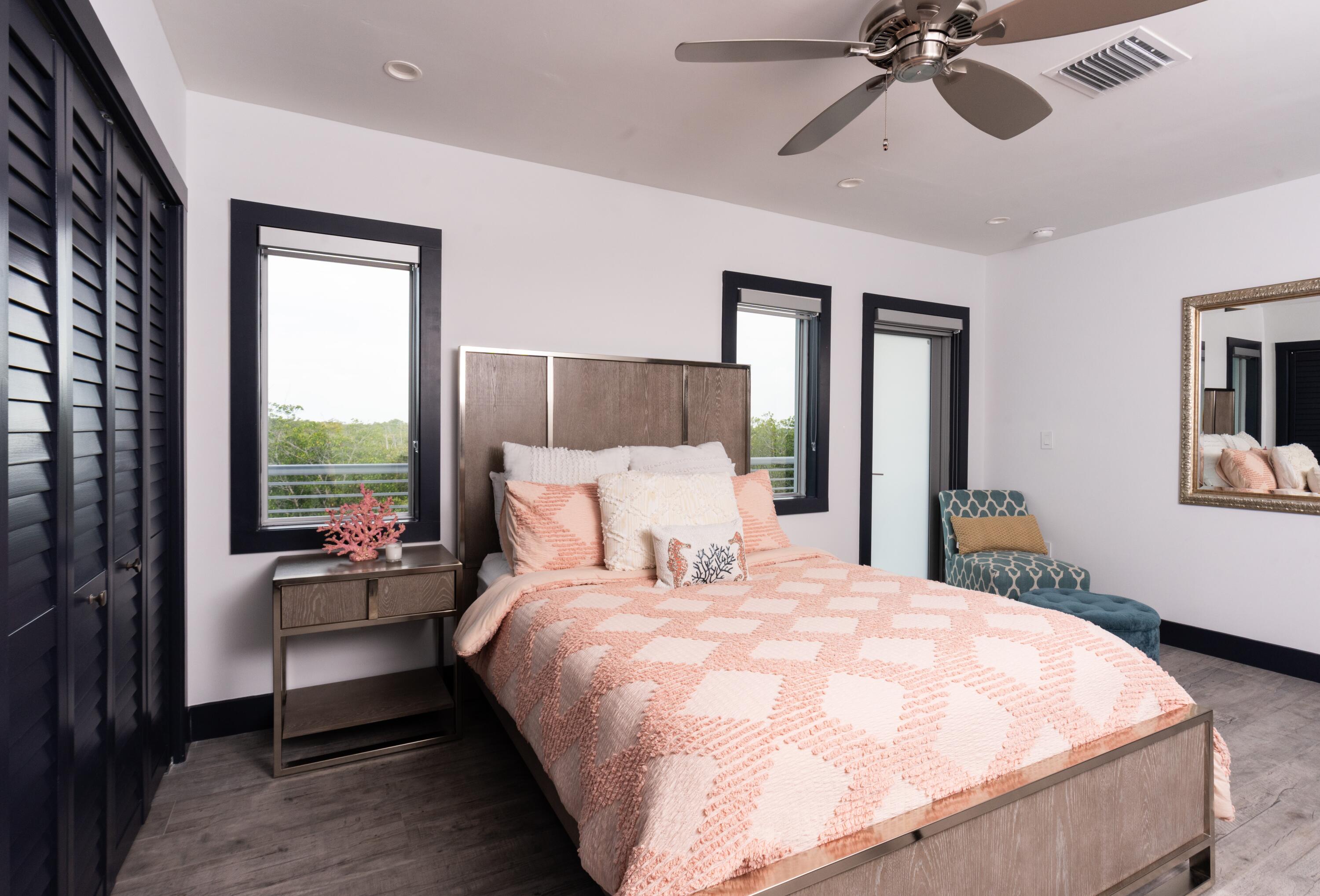 475 Bahia Honda Road Key Largo, FL 33037 - Photo 65 of 134 a bedroom with a large bed and a chandelier