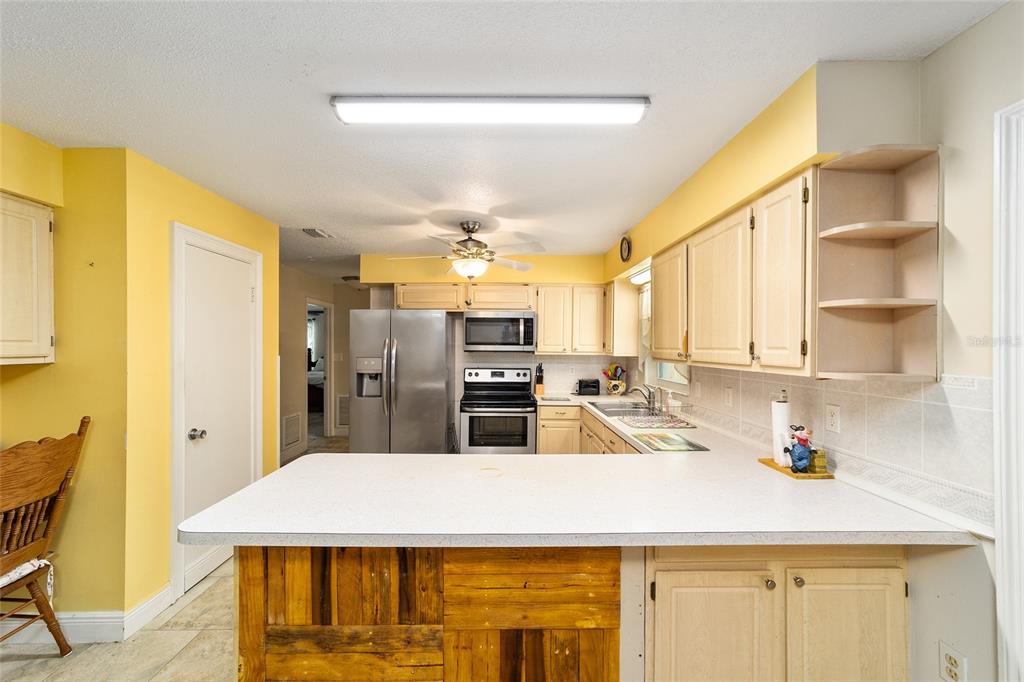 11 Brook Place Ocala, FL 34472 - Photo 12 of 27 a kitchen with stainless steel appliances kitchen island granite countertop a sink and cabinets