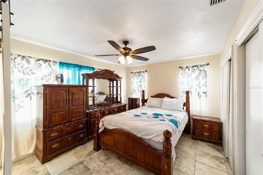 11 Brook Place Ocala, FL 34472 - Photo 17 of 27 a bed room with a bed and a ceiling fan