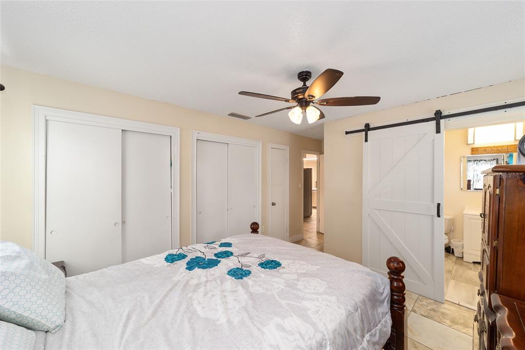 11 Brook Place Ocala, FL 34472 - Photo 18 of 27 a bedroom with a bed and a chandelier