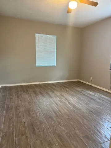 a view of a room with wooden floor and white walls