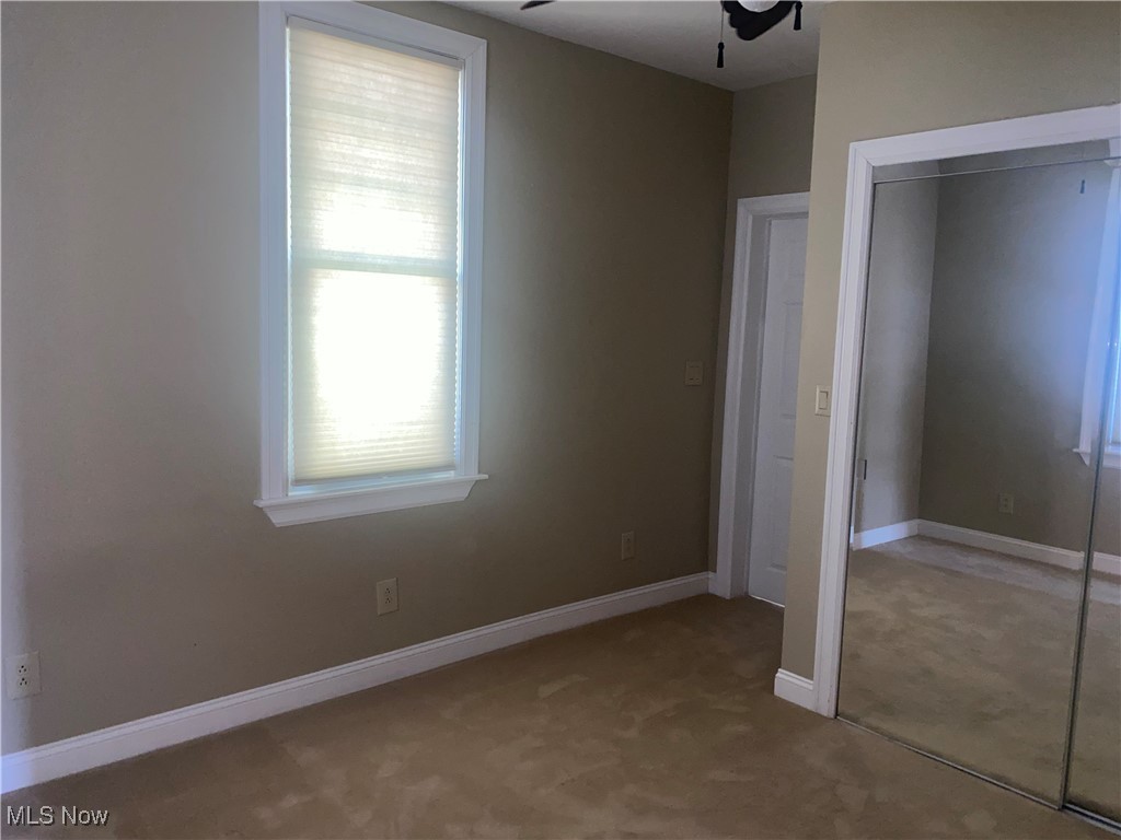 3016 Wadsworth Road Norton, OH 44203 - Photo 23 of 50 First floor bedroom featuring a closet, ceiling fan, and carpet