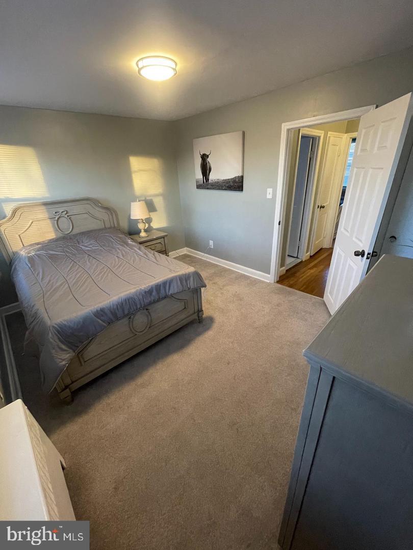 3654 Clarenell Road Baltimore, MD 21229 - Photo 12 of 15 a spacious bedroom with a bed and a dresser