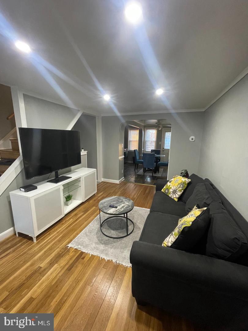 3654 Clarenell Road Baltimore, MD 21229 - Photo 5 of 15 a living room with furniture and a flat screen tv