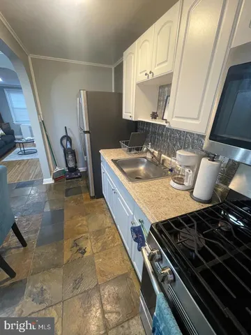 a kitchen with a stove and a sink