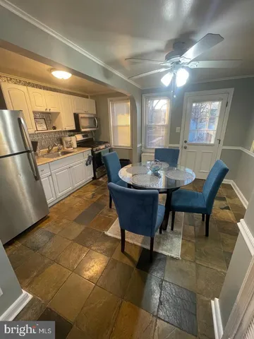 a kitchen with a dining table and chairs