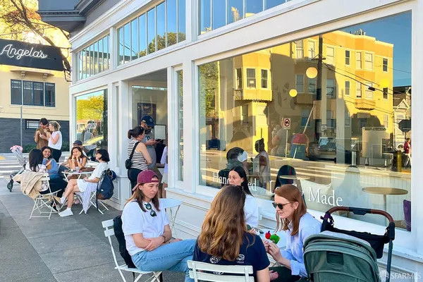 a view of store with outdoor seating