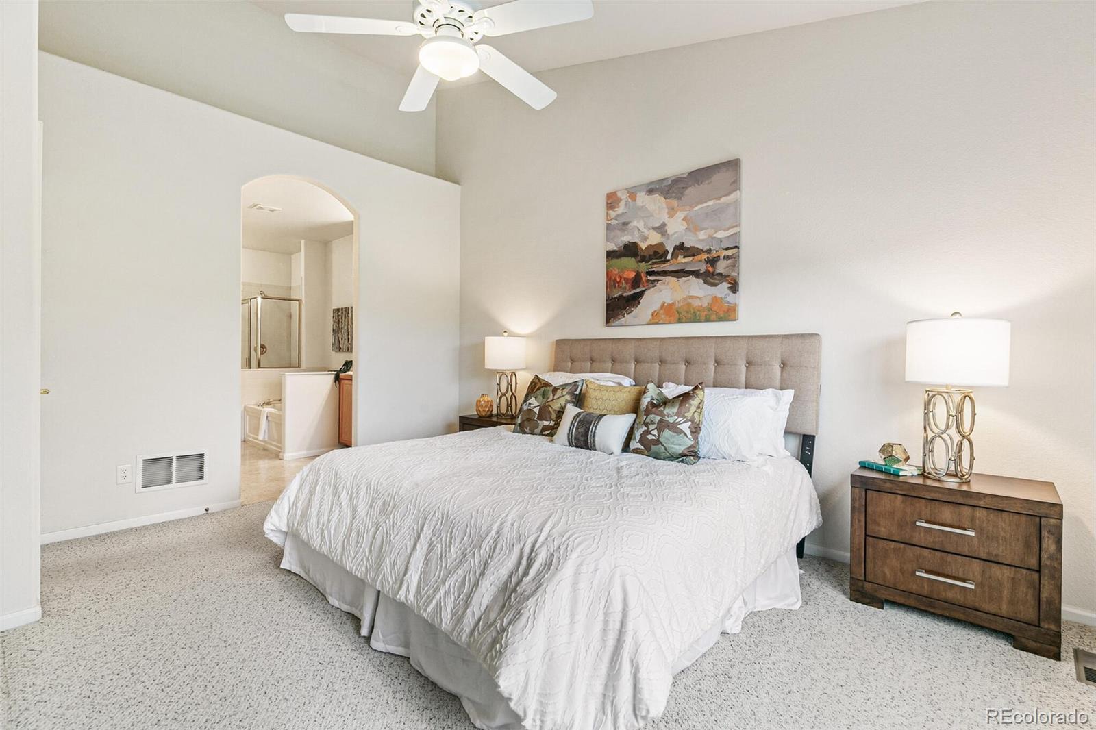 6577 South Reed Way, Unit B Littleton, CO 80123 - Photo 20 of 46 a bedroom with a bed and a chandelier