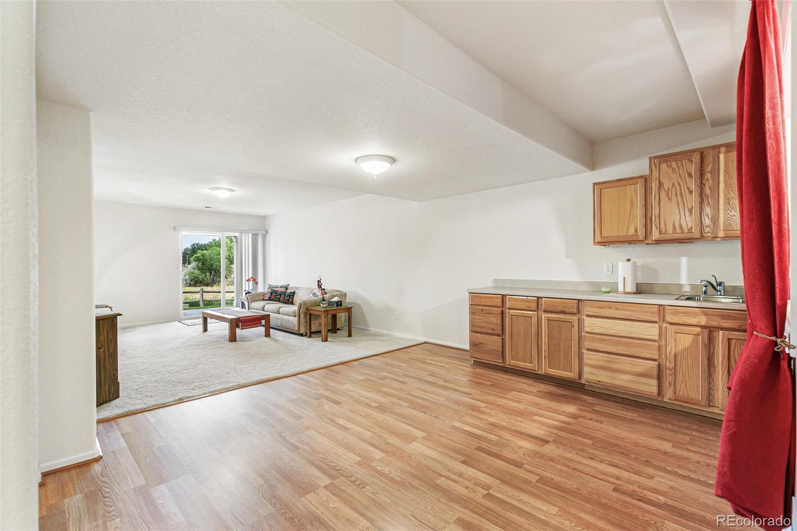 6577 South Reed Way, Unit B Littleton, CO 80123 - Photo 26 of 46 a living room with furniture and a wooden floor