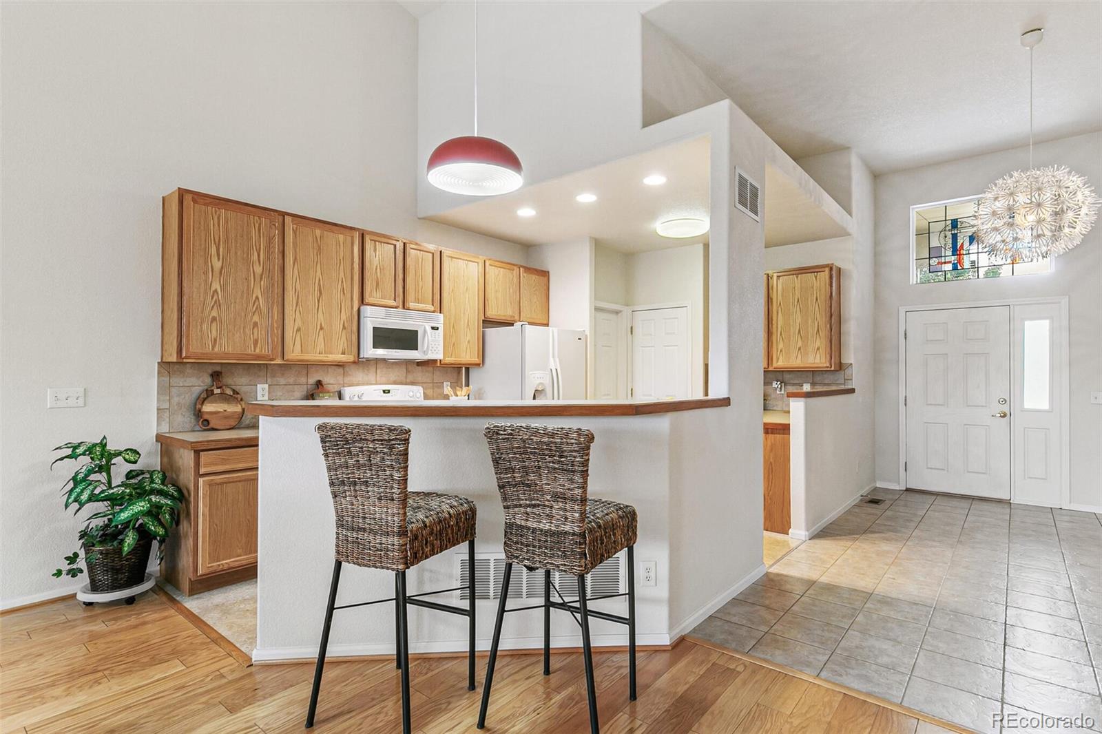 6577 South Reed Way, Unit B Littleton, CO 80123 - Photo 8 of 46 a kitchen with stainless steel appliances granite countertop a refrigerator and a stove top oven