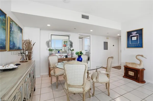 a kitchen with stainless steel appliances kitchen island granite countertop a table and chairs in it