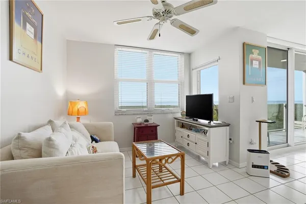 a living room with lots of furniture and kitchen view