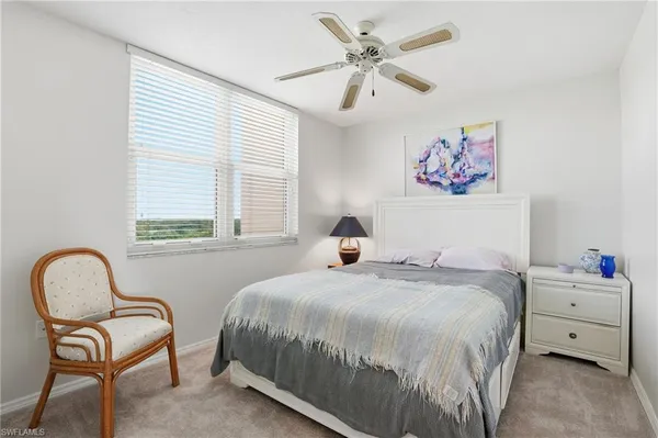 a bedroom with a bed desk and chair