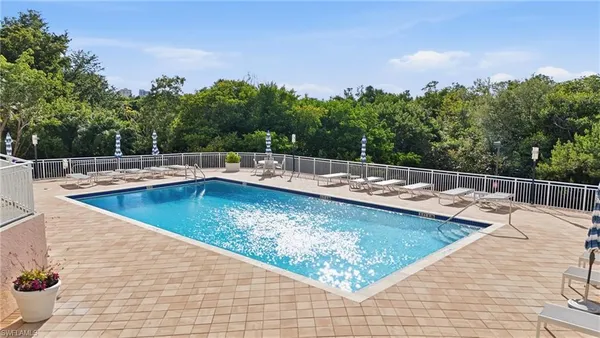 a view of a house with pool and chairs