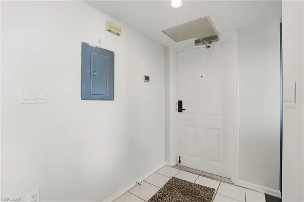a living room with furniture a flat screen tv and a table
