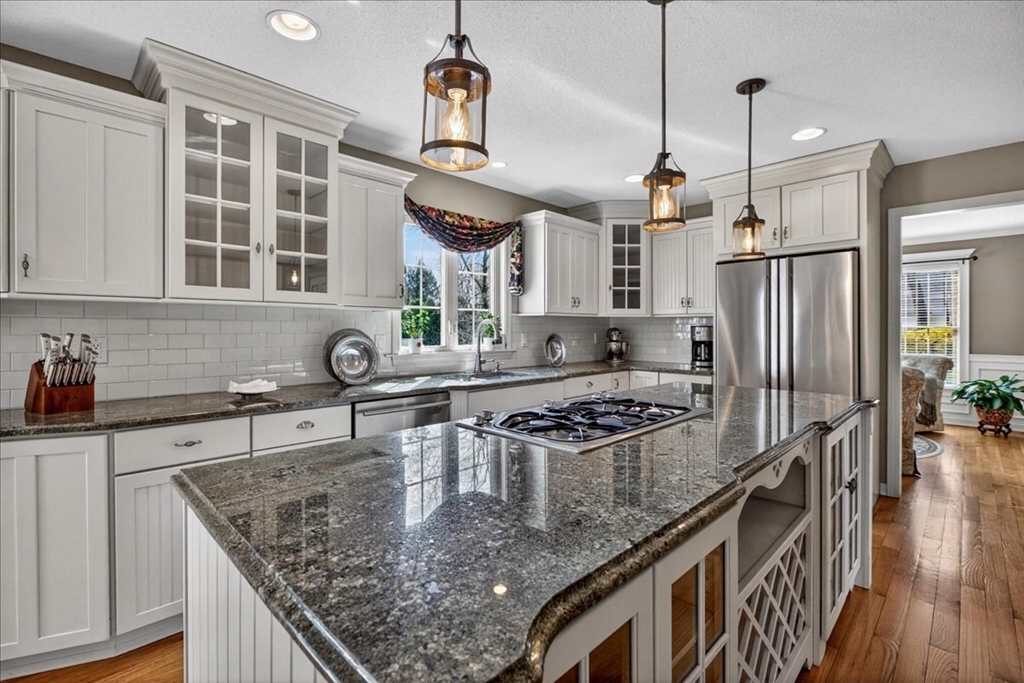 1318 Piper Road West Springfield, MA 01089 - Photo 16 of 42 a kitchen with stainless steel appliances granite countertop a sink a stove and a wooden floors